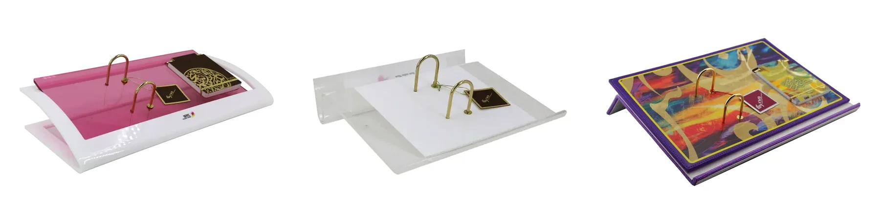Three desk calendars made for clients: pink and white bent acrylic, clear acrylic, and purple photo-printed leather